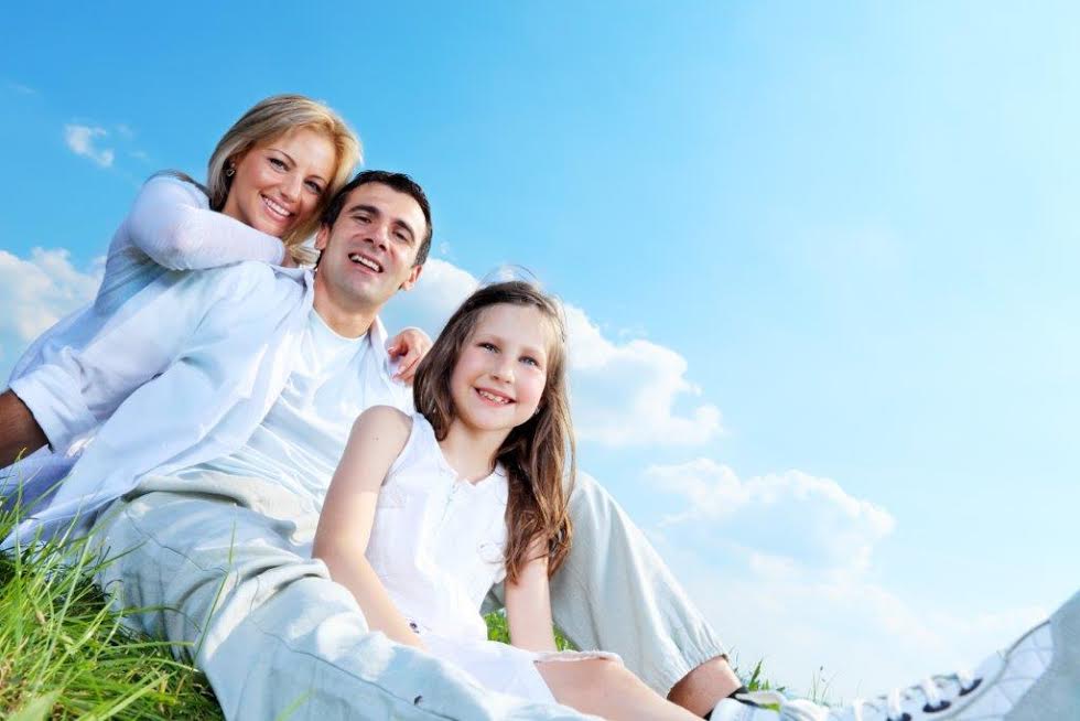 young family photo on grass