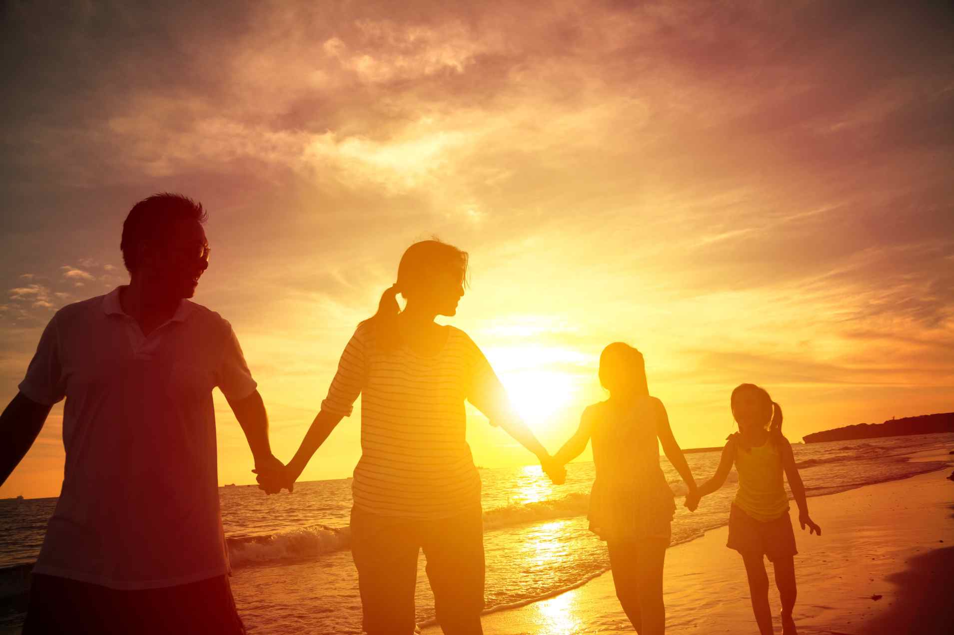 holding hands at sunset