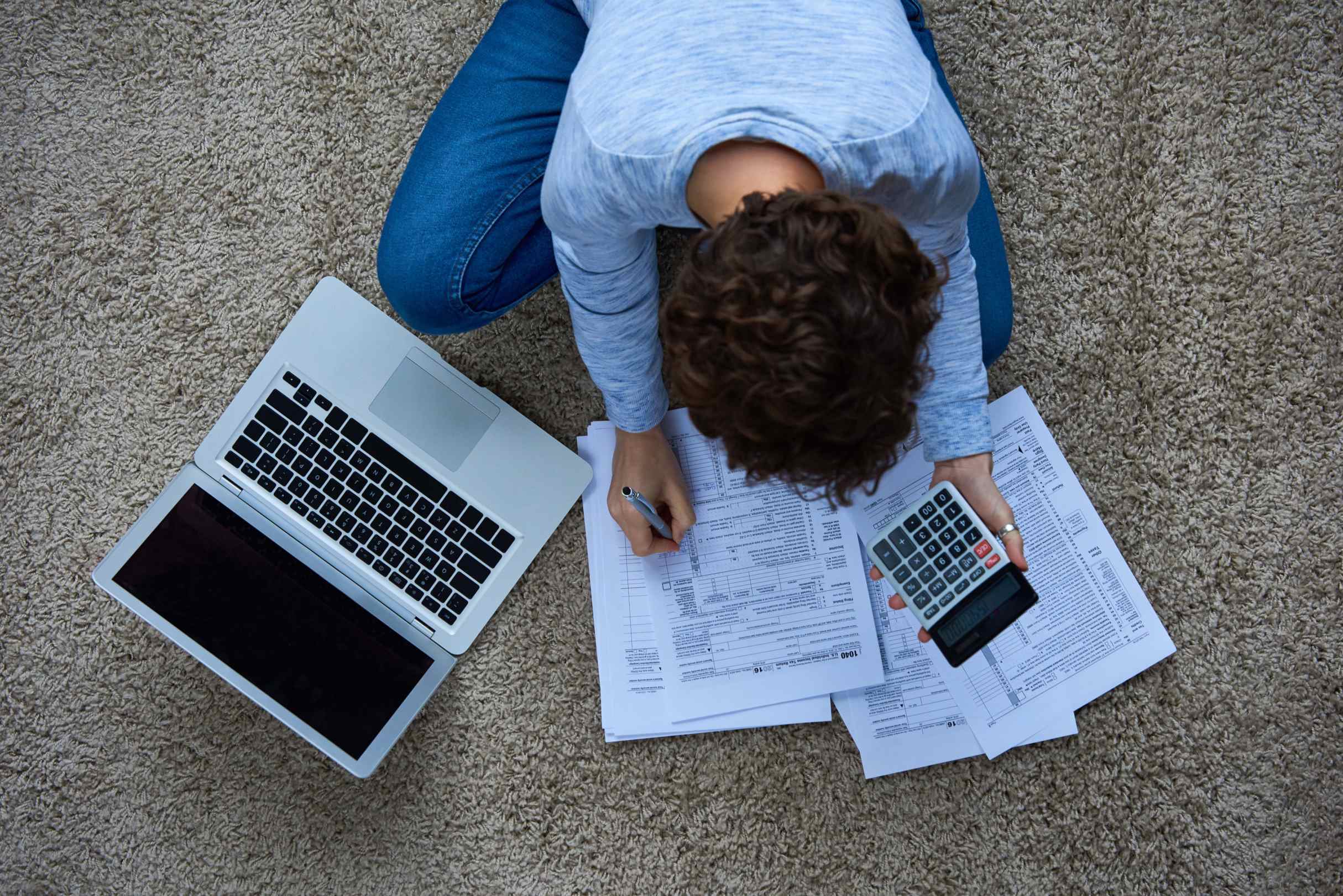 sitting on floor working on taxes